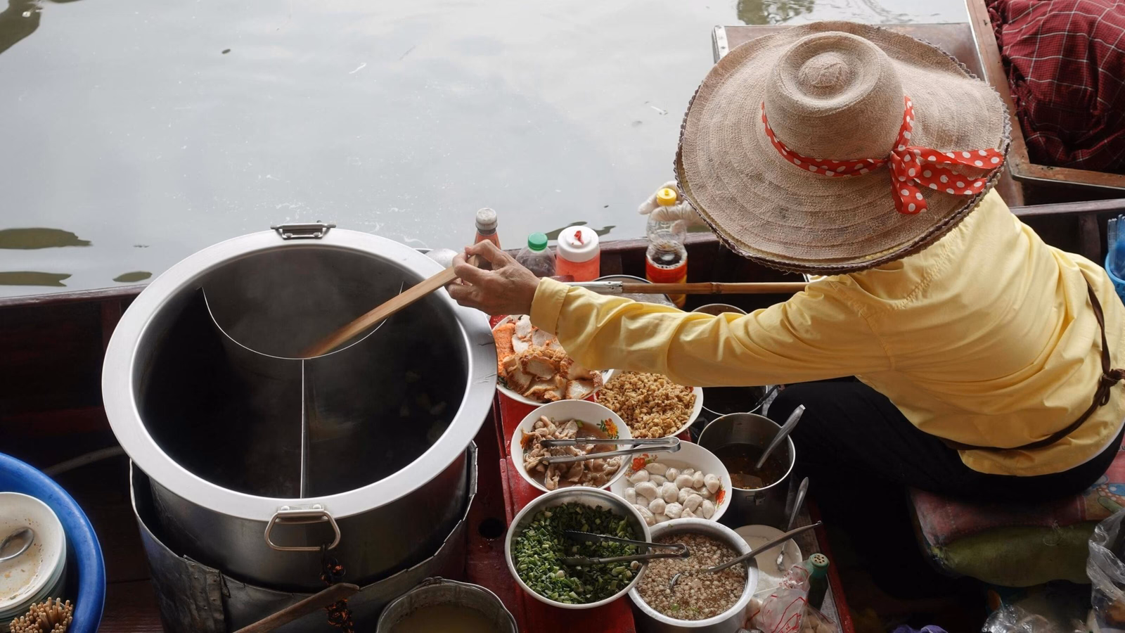 Woman in Thailand selling food in the renowned floating markets