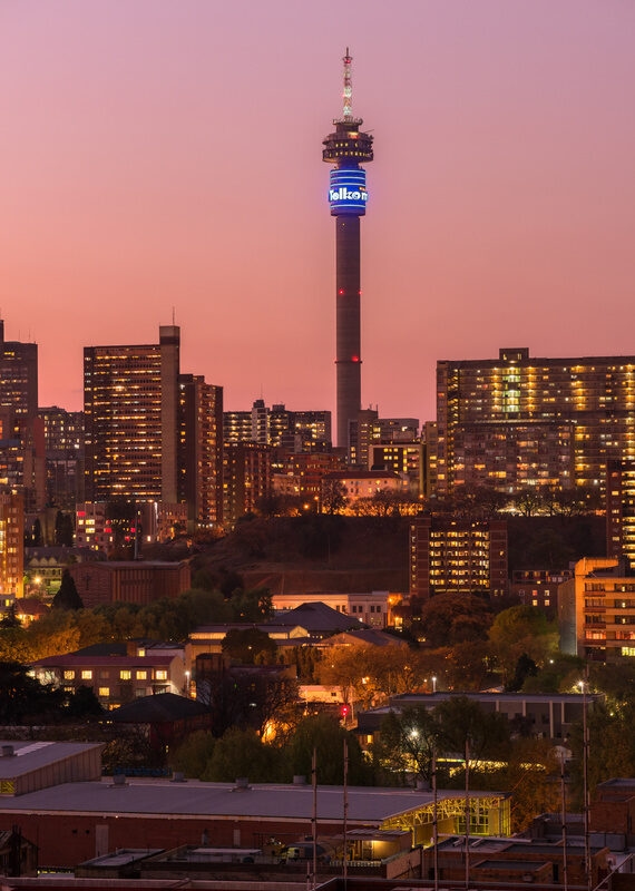 Vertical cityscape of Johannesburg skyline with pink sky from sunset