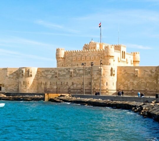 The stone Citadel of Qaitbay fortress overlooks the blue waters of the Mediterranean Sea in Alexandria.