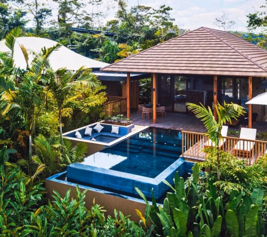 A wooden villa with open sides and private pool and terrace surrounded by greenery at Nayara Tented Camp in Costa Rica