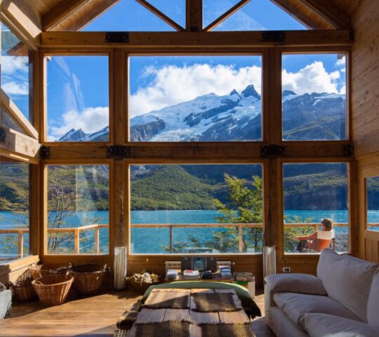Living room at Aguas Arribas with full sized widow looking out onto a lake view