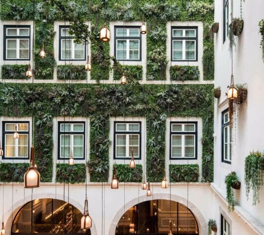 An interior courtyard with living wall covering the building at Palacio Ludovice in Lisbon