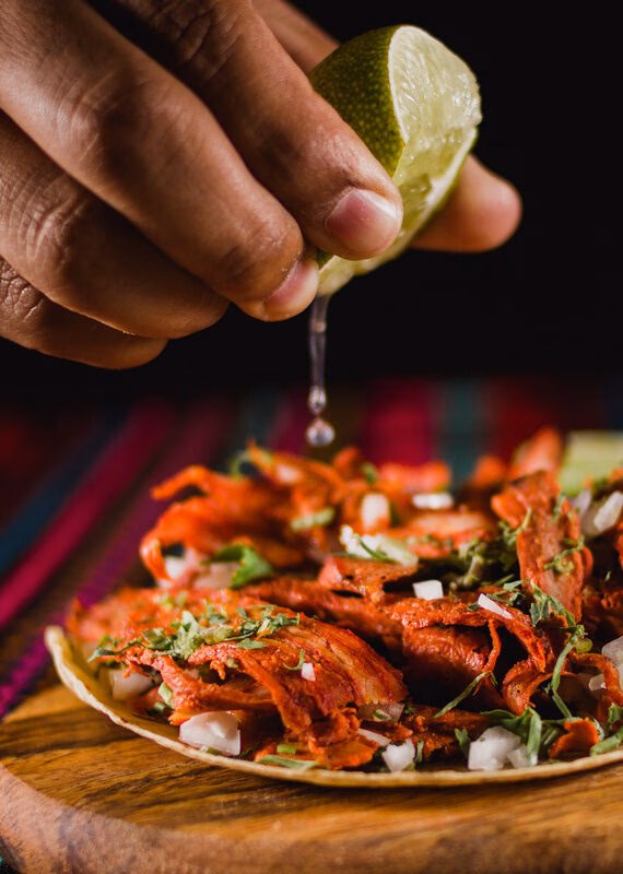 Squeezing a lime onto a Mexican street taco during a Mexico family vacation.