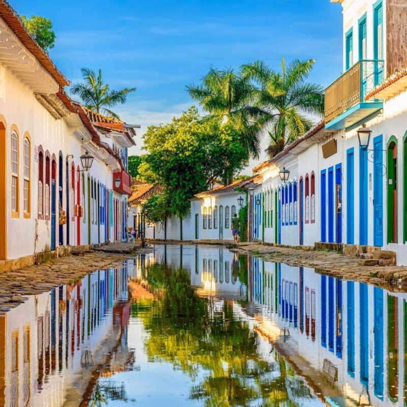 historic buildings reflected in a flooded street in Paraty, Brazil, during a family trip.