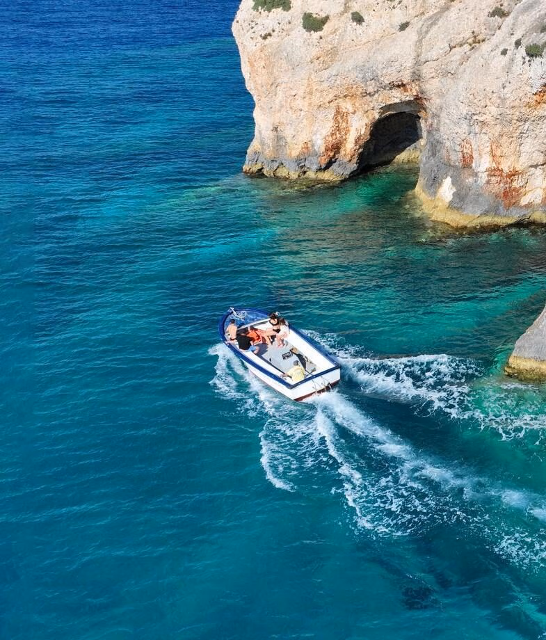 The floor of Samaria Gorge National Park in Crete, and a private boat across the turquoise waters near Corfu’s Blue Caves.