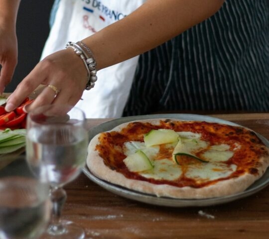 A woman's hands preparing fresh food as part of a cooking class in France
