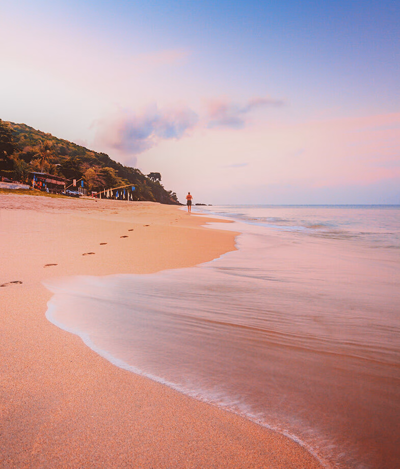 A lush green trail in Cuc Phuong National Park in Vietnam and Koh Lanta beach in Thailand at sunset.