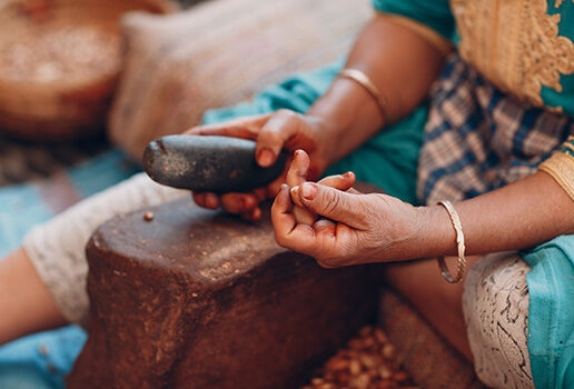 A woman demonstrates how to make argan oil.