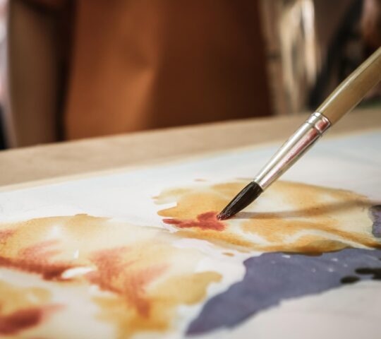 Close up of a watercolour painting with paint brush