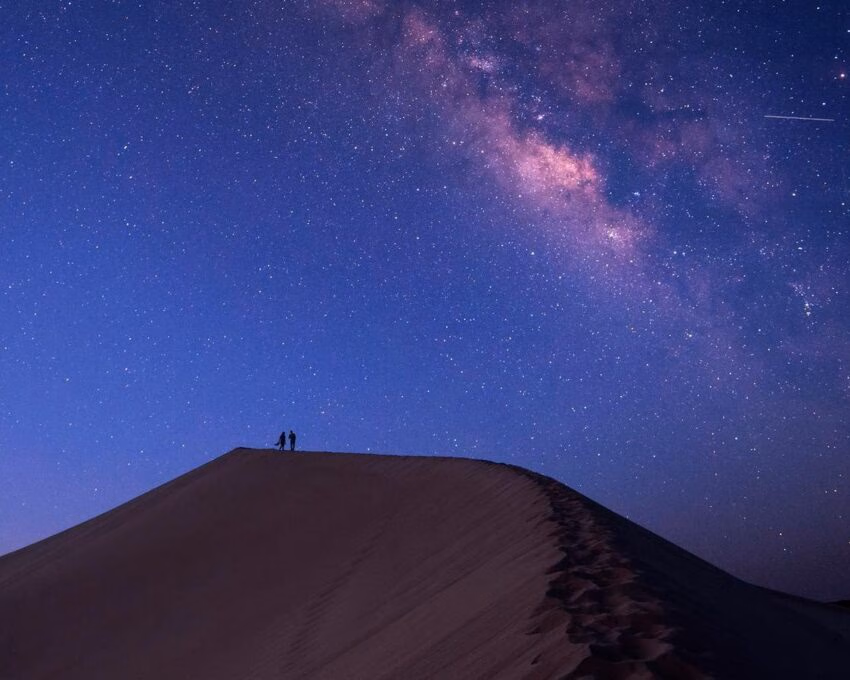 A starry sky over sand dunes in the Moroccan Sahara