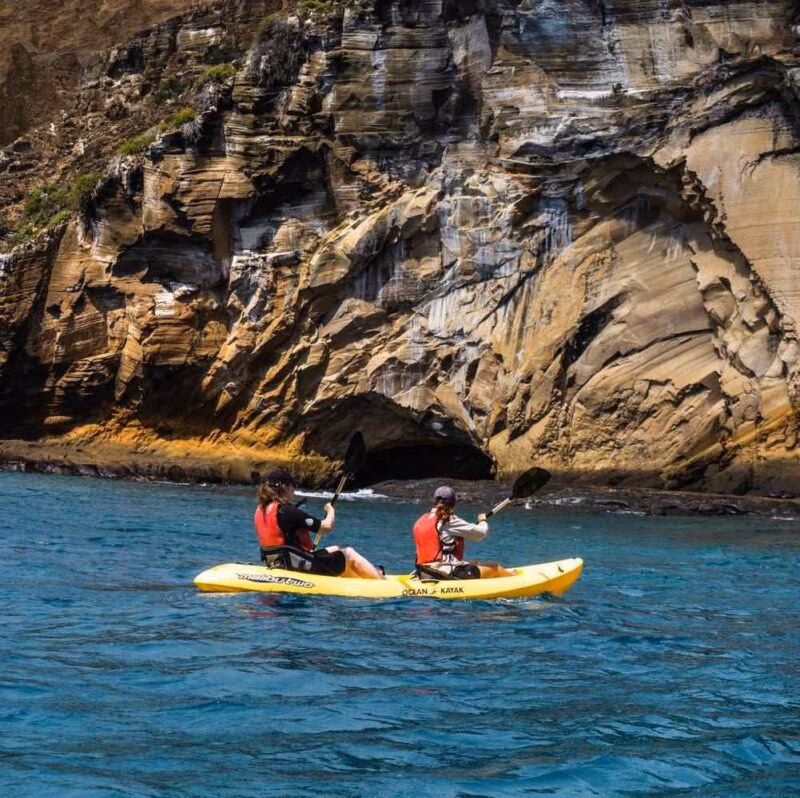 Two women kayaking in the sea around the Galapagos islands