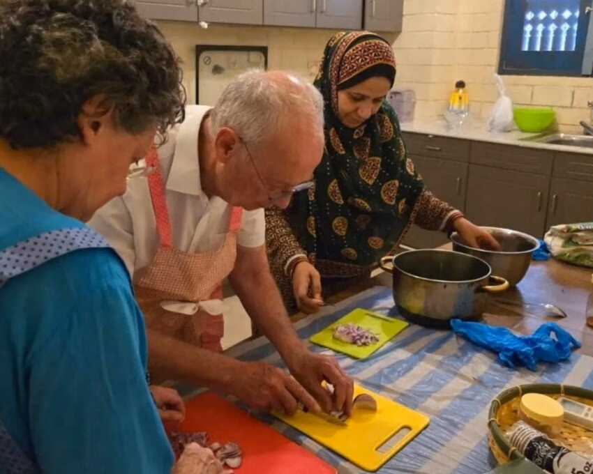 A couple taking part in a cooking class as part of an Omani culture experience