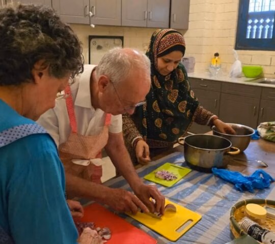 A couple taking part in a cooking class as part of an Omani culture experience