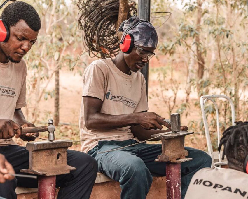 Men working with metal and tools at the Jafuta Foundation in Zimbabwe