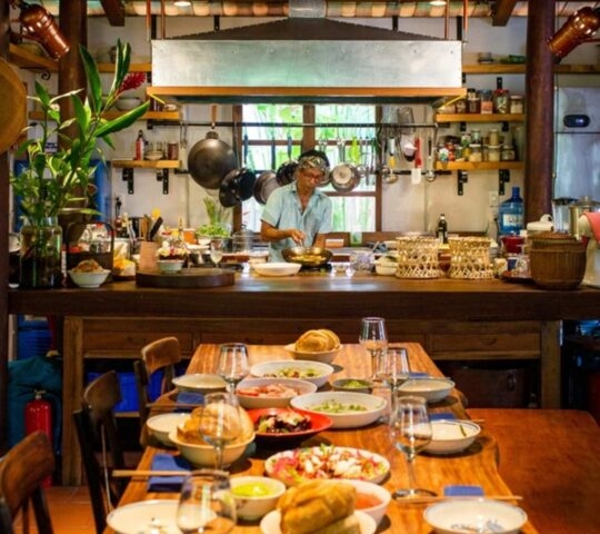 A chef preparing a traditional private dinner for guests in Vietnam