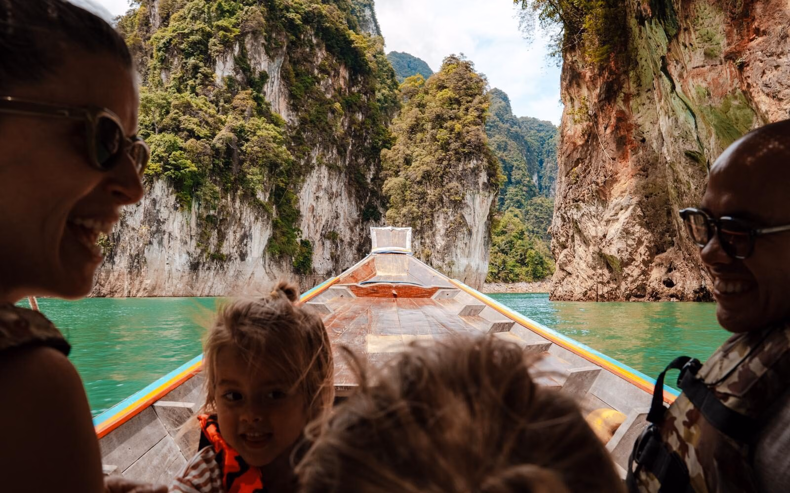 Explore Thailand’s dramatic limestone landscapes by traditional long-tail boat on a family trip. These towering karsts have been carved over millions of years as water slowly dissolved the ancient limestone.