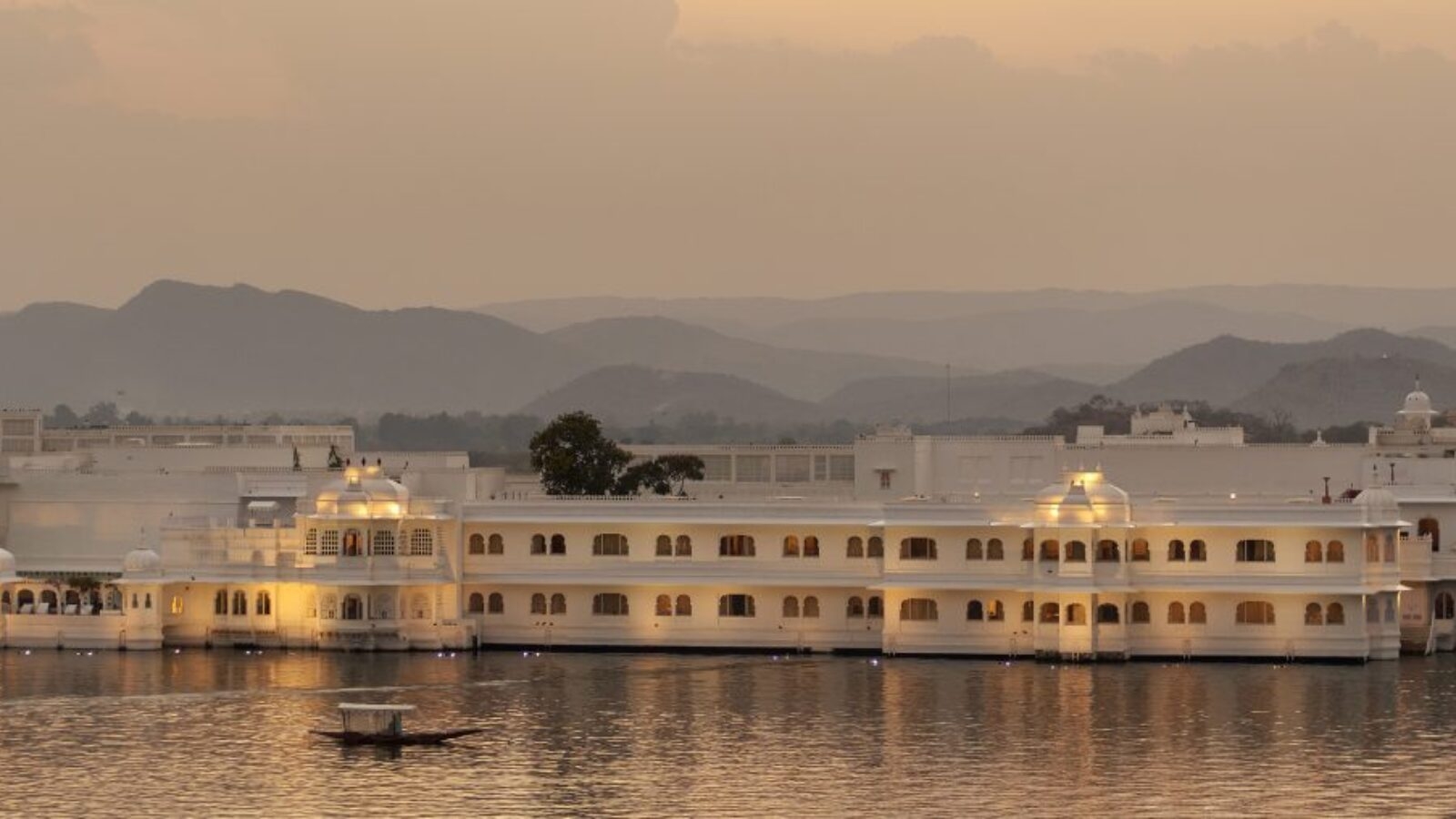 A grand luxury hotel that looks like a palace on a lake