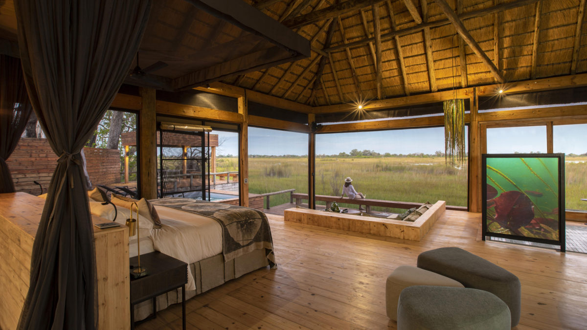 A Vumburu Plains safari camp bedroom with a view of the plains and natural surroundings