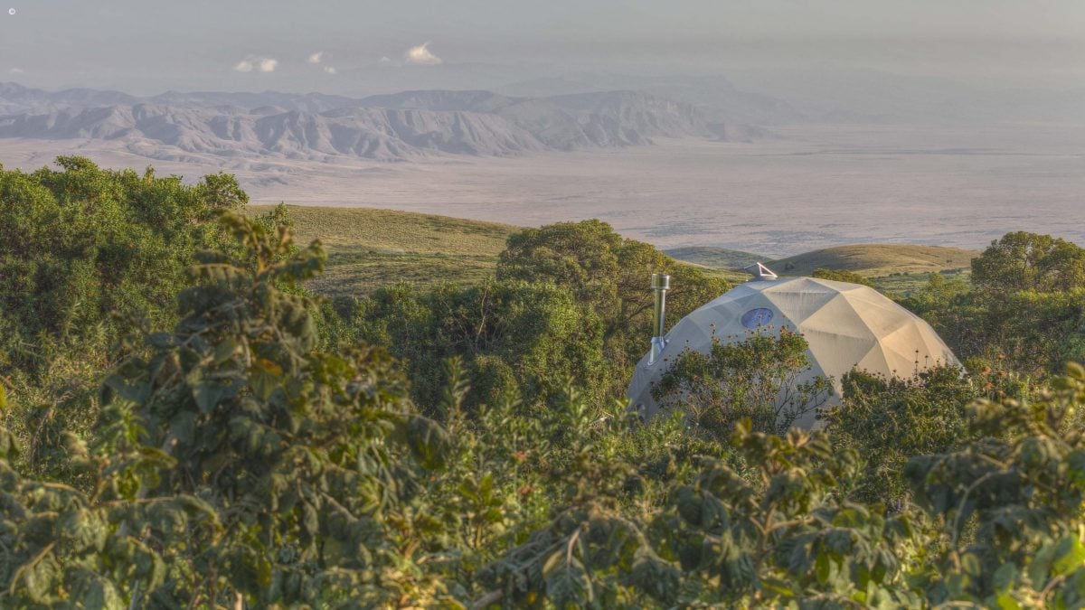 Geodesic dome of The Highlands Ngorongoro set within lush green foliage, Ngorongoro Crater Tanzania