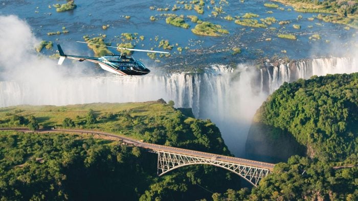 Aerial view of Victoria Falls Bridge at Victoria Falls, Livingstone with helicopter