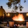 Exterior with camp fire in the evening at Singita Boulders Lodge, Sabi Sands, South Africa