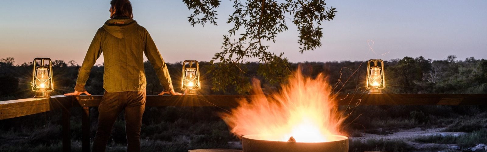 Exterior with camp fire in the evening at Singita Boulders Lodge, Sabi Sands, South Africa