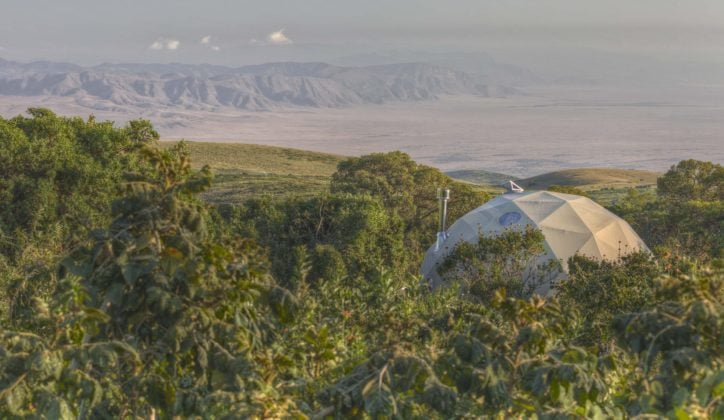 Geodesic dome of The Highlands Ngorongoro set within lush green foliage, Ngorongoro Crater Tanzania