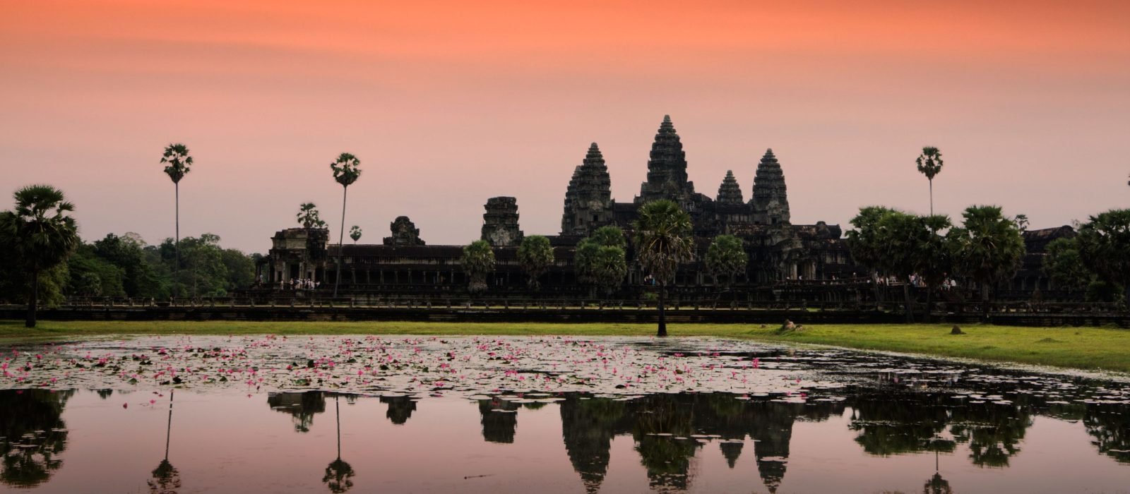 Reflection of Angkor Wat, Cambodia, in the red and pink hues of sunset