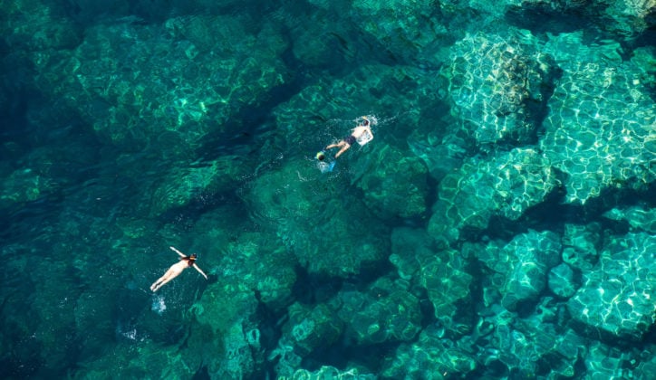 Couple snorkelling in the clear turquoise waters of Zanzibar, Tanzania