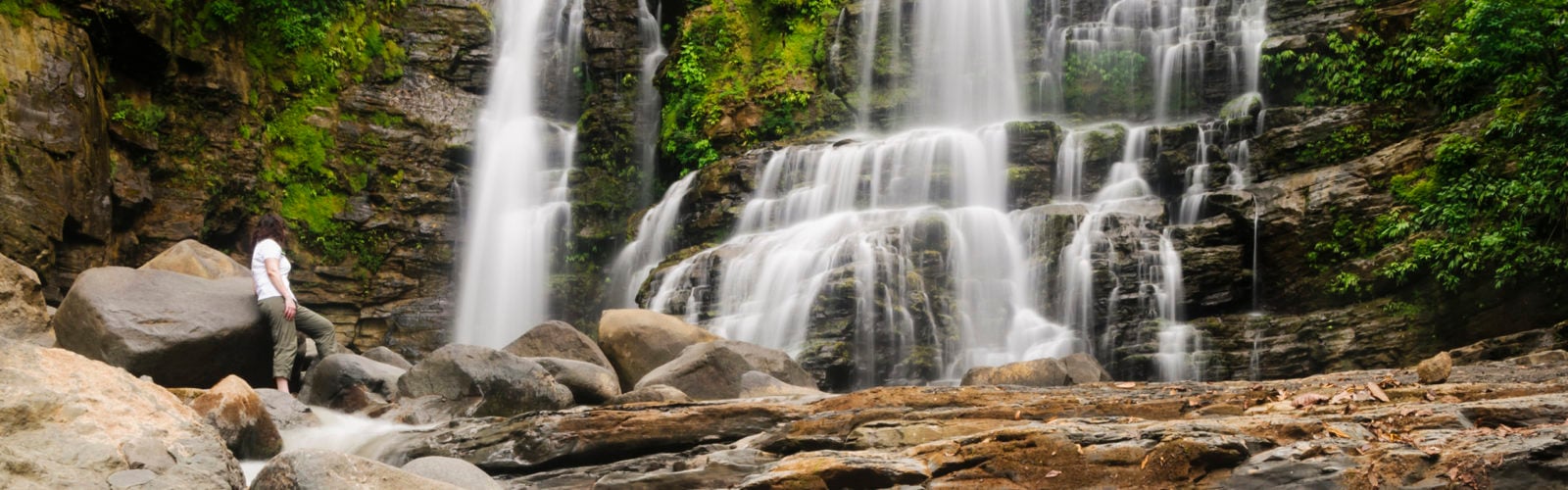 Traveller watching Nauyuca Waterfall, Dominical, Costa Rica.