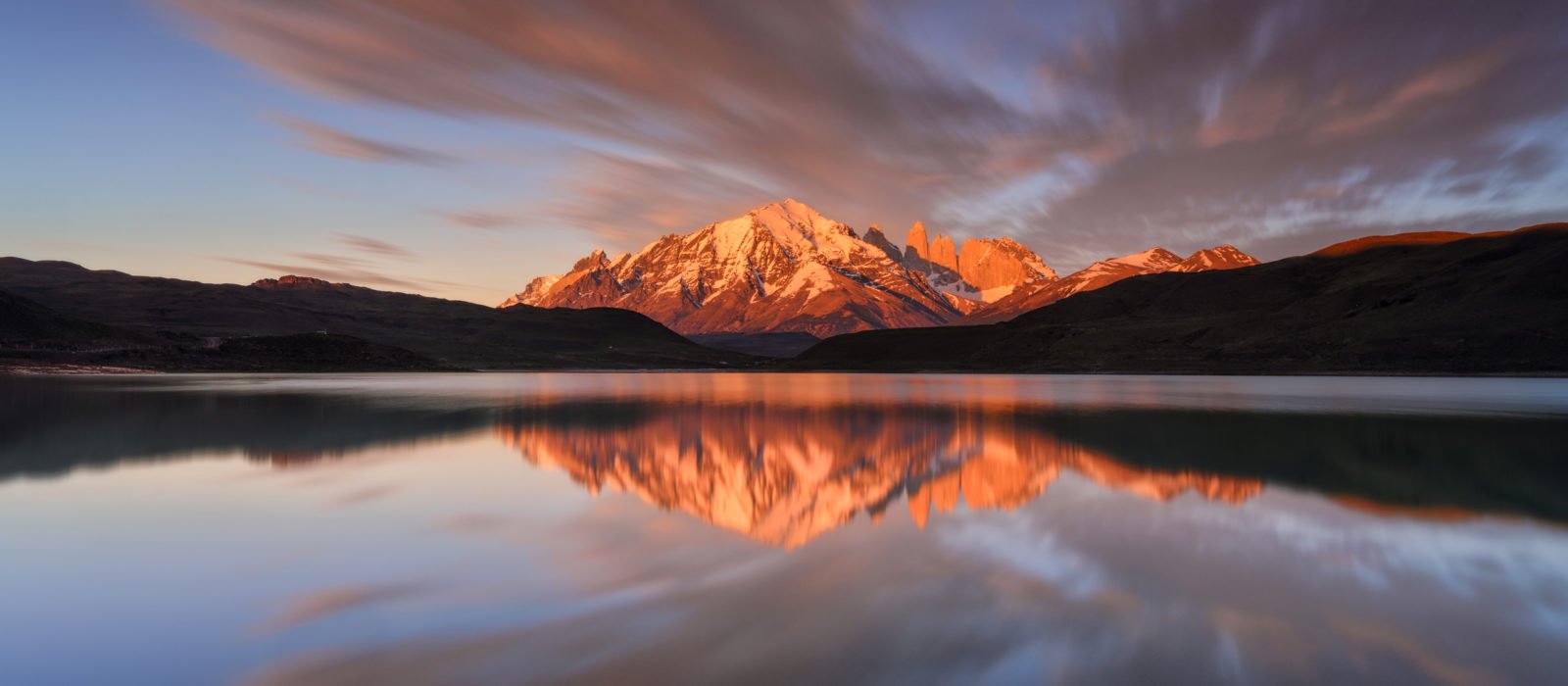 Snow-capped mountain reflecting in the water at sunset, Torres del Paine