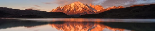 Snow-capped mountain reflecting in the water at sunset, Torres del Paine