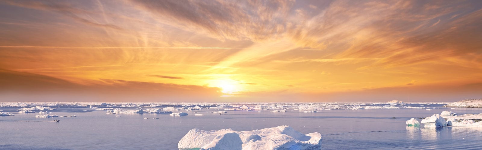 Sunset strikes the icebergs near Ilulissat