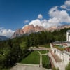 Gardens of The Cristallo set against the rugged peaks, Cortina d'Ampezzo Italy