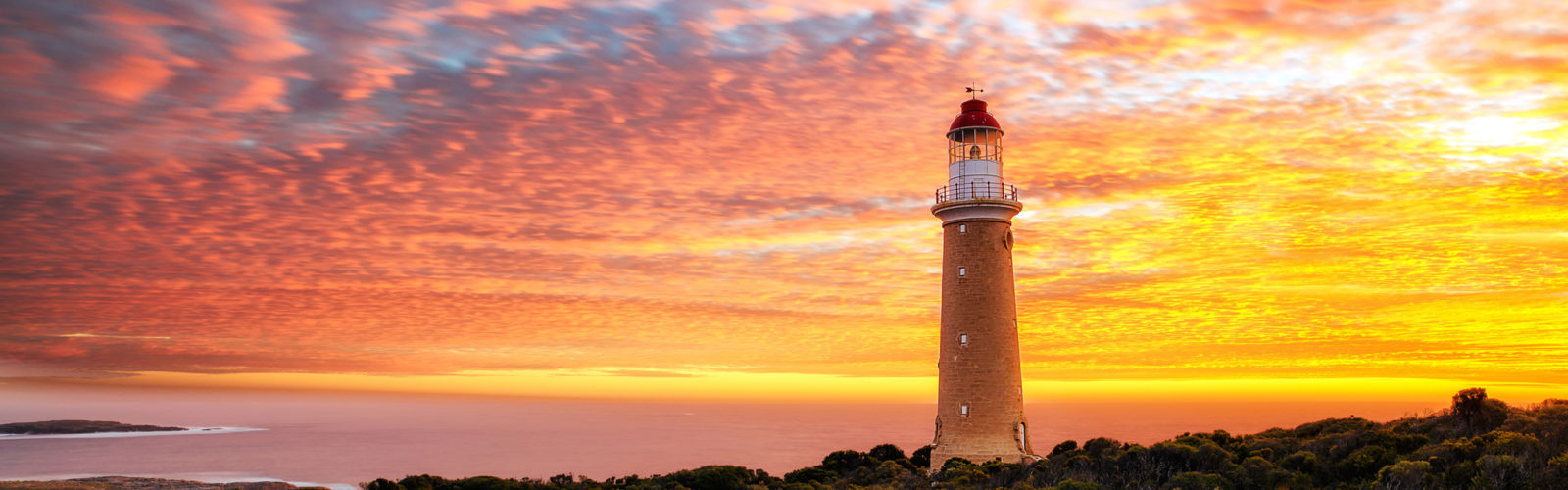 The lighthouse at Cape Du Couedic on Kangaroo Island, with the sun setting in the background