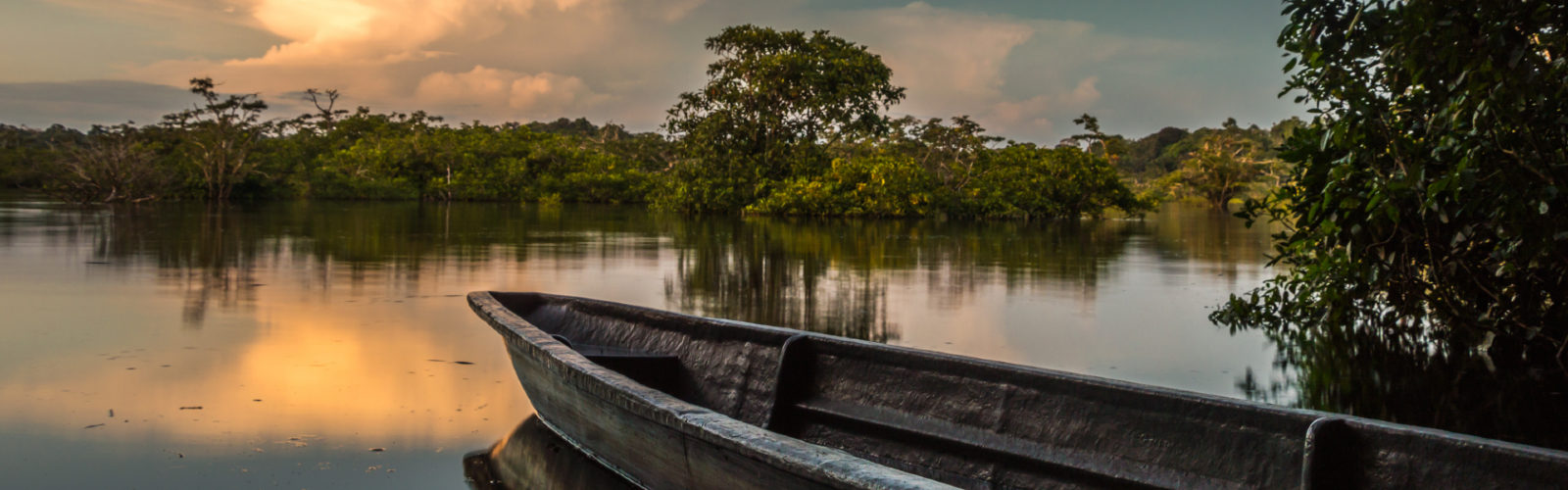A boat sits on the water amid Ecuador's Amazon