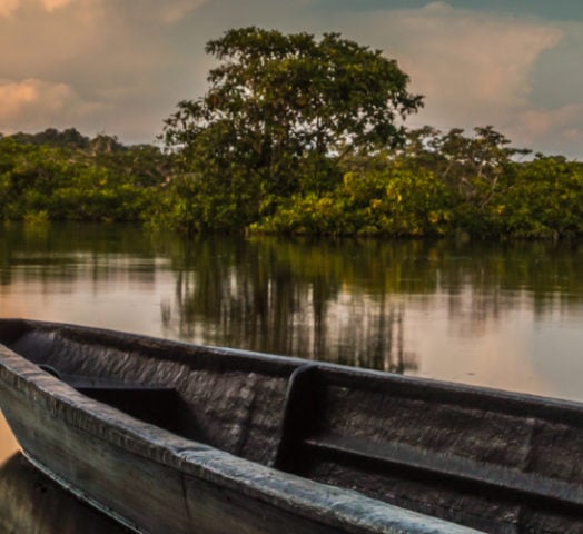 A boat sits on the water amid Ecuador's Amazon