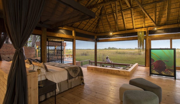 A Vumburu Plains safari camp bedroom with a view of the plains and natural surroundings