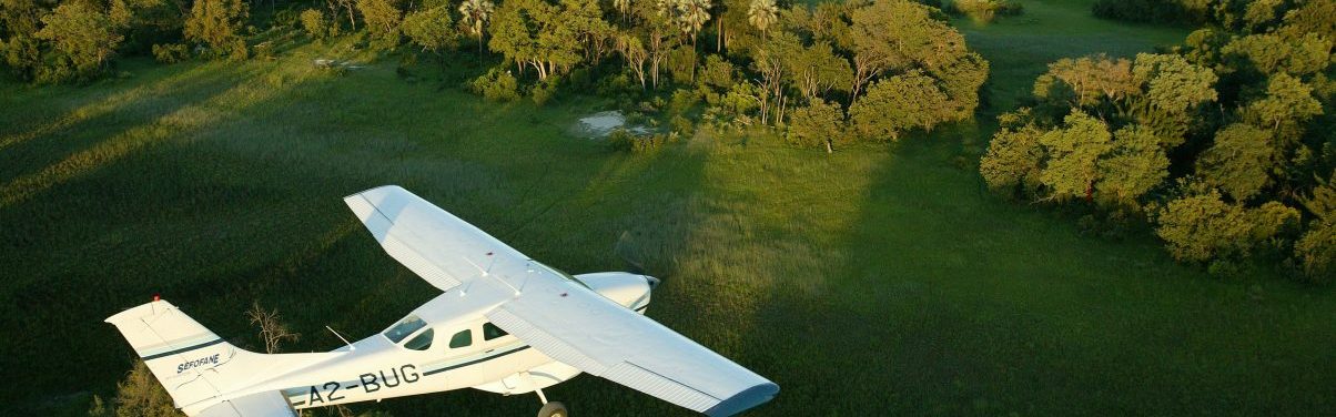 A caravan plane flies over the Okavango Delta