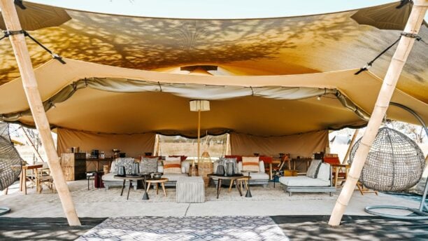 Open lounge of luxury safari camp Wilderness Usawa with sunlight and sofas, Serengeti National Park Tanzania