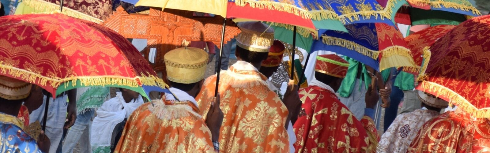Timkat festival in Ethiopia with priests holding colourful umbrellas