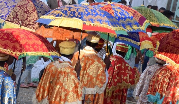 Timkat festival in Ethiopia with priests holding colourful umbrellas