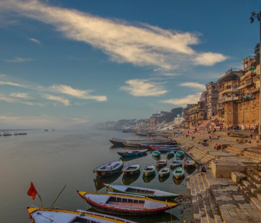 early morning view of famous ghats of varanasi where wooden boats lined up