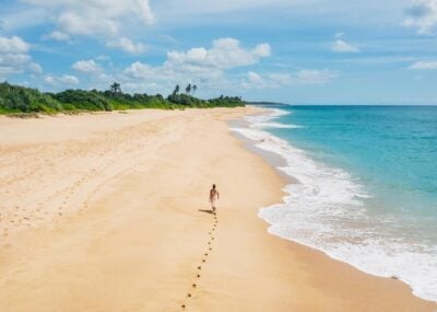 Person walking on a beach in Tangalle, Sri Lanka