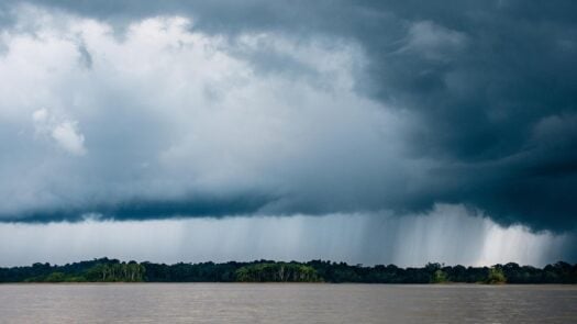 Dramatic clouds raining on the Amazon rainforest