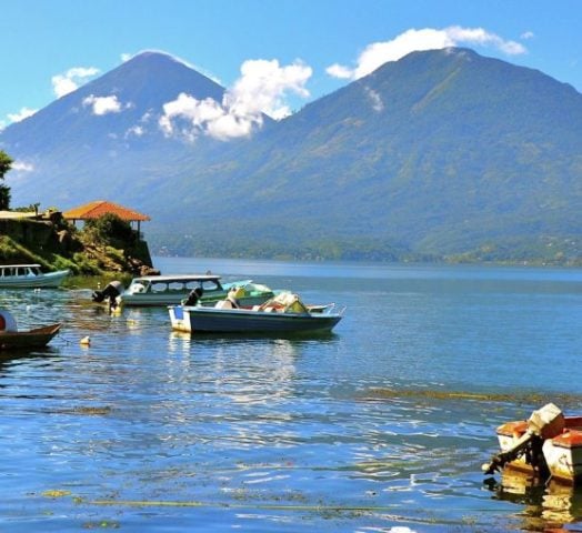 Boats moored on Lake Atitlan in Guatemala against a mountainous backdrop